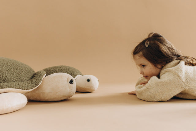 The Plushly Kid playing with Stuffed Toy